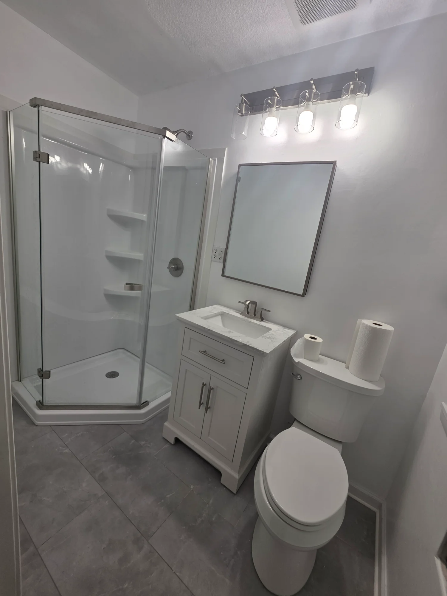 Bathroom after remodel - corner shower with glass door