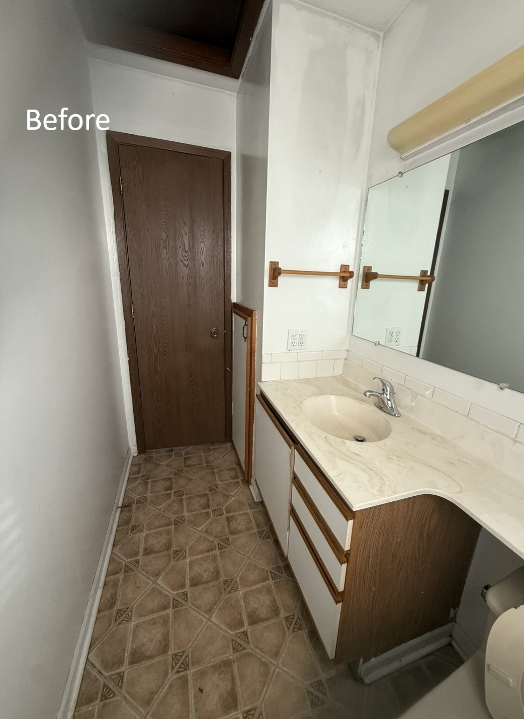 Bathroom before remodel - door and vanity